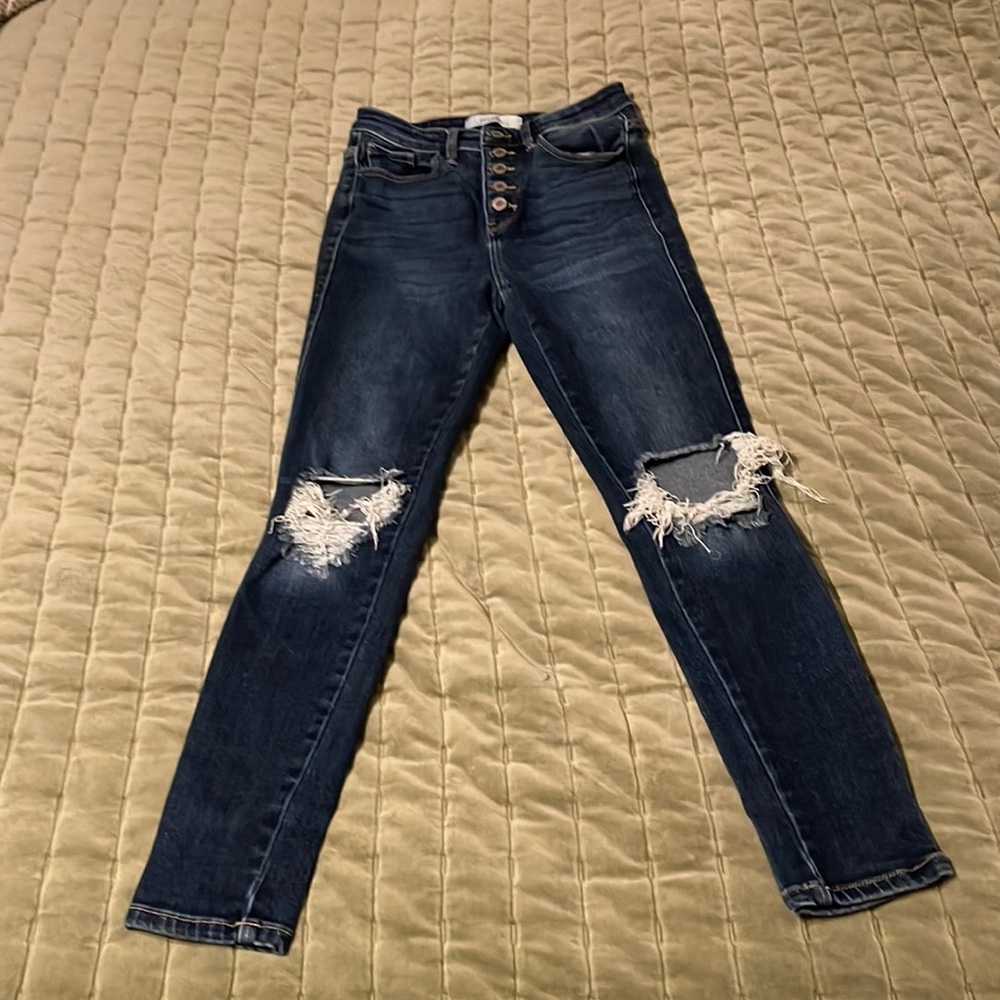 Size 26 skinny jeans with holes in knees.